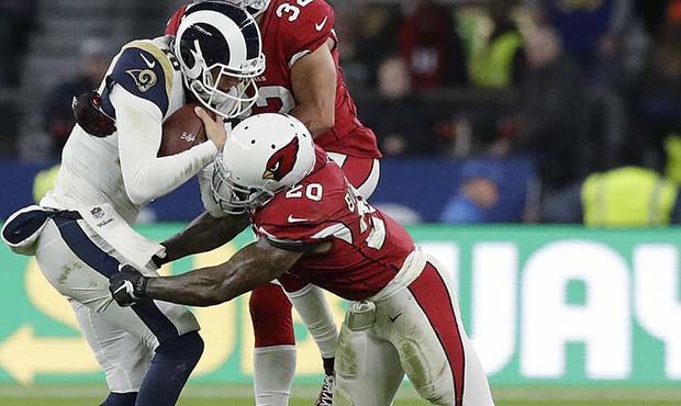 Los Angeles Rams quarterback Jared Goff (16) is tackled by Arizona Cardinals' Tyrann Mathieu (32) a...