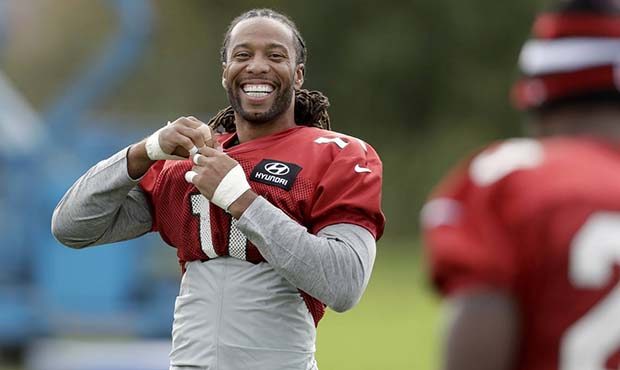 Arizona Cardinals wide receiver Larry Fitzgerald, 11, and running back Adrian Peterson, foreground,...