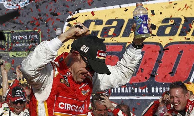 Matt Kenseth celebrates his win in Victory Lane after a NASCAR Cup Series auto race at Phoenix Inte...
