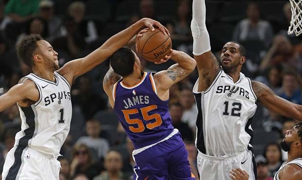 San Antonio Spurs' Kyle Anderson(1) blocks a shot attempt by Phoenix Suns' Mike James(55) during th...
