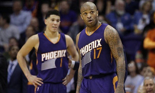 Phoenix Suns' P.J. Tucker (17) and Devin Booker (1) react to a foul call during the second half of ...