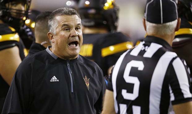 Arizona State coach Todd Graham, left, argues with an official during the first half of an NCAA col...
