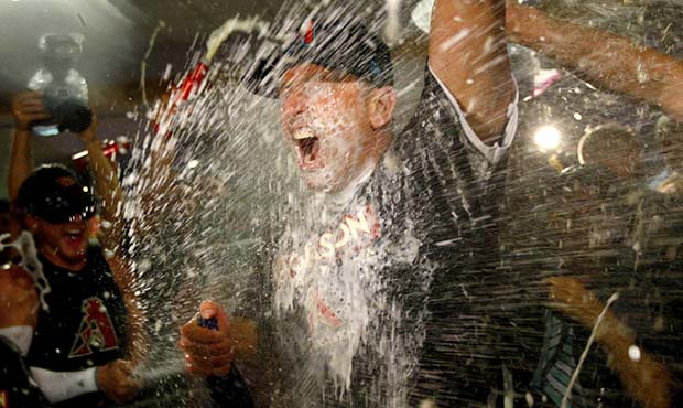Arizona Diamondbacks manager Torey Lovullo is sprayed by his team after the National League wild-ca...