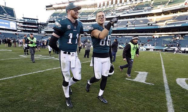 Philadelphia Eagles' Carson Wentz, left, and Zach Ertz walk off the field after an NFL football gam...
