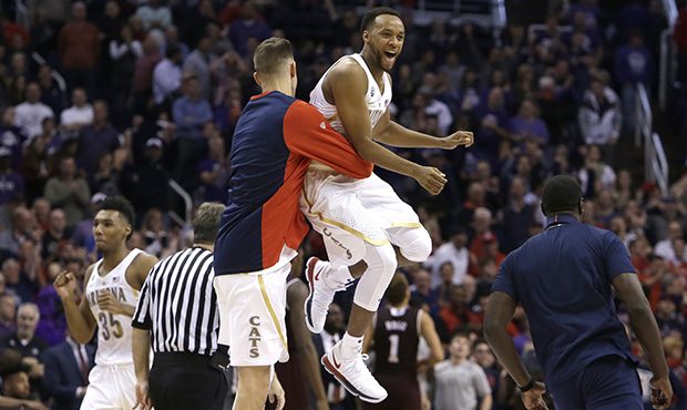 Arizona guard Parker Jackson-Cartwright, right, celebrates with a teammate after defeating Texas A&...
