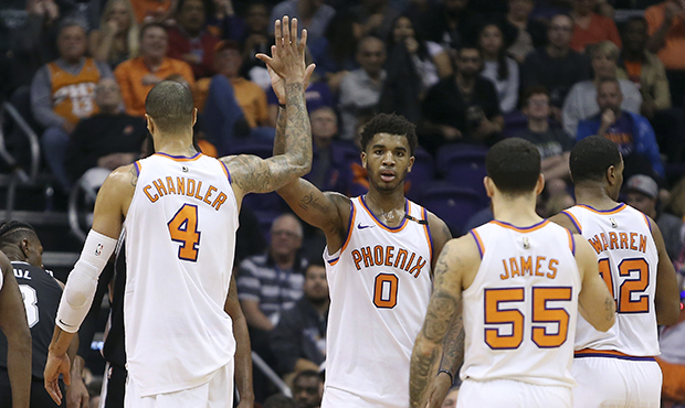 Phoenix Suns forward Marquese Chriss (0) is congratulated by teammate Tyson Chandler (4) after a ba...