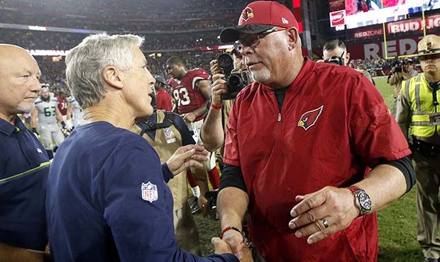 Seattle Seahawks head coach Pete Carroll, left, greets Arizona Cardinals head coach Bruce Arians af...