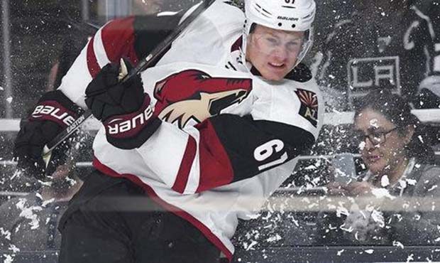 Arizona Coyotes left wing Lawson Crouse hits the glass as he passes the puck during the third perio...