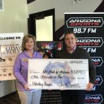 (Arizona Sports Photo) CEO Adam Wilkes of Just Sports donating at Burns and Gambo's Holiday Heroes event which raised thousands for the 100 Club of Arizona and first responders.