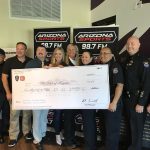 (Arizona Sports Photo) The City of Surprise donating at Burns and Gambo's Holiday Heroes event which raised thousands for the 100 Club of Arizona and first responders.