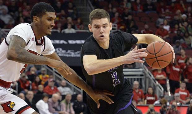 Grand Canyon forward Roberts Blumbergs (12) attempts to drive past the defense of Louisville forwar...