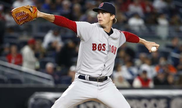Boston Red Sox starting pitcher Henry Owens winds up during the first inning of a baseball game aga...
