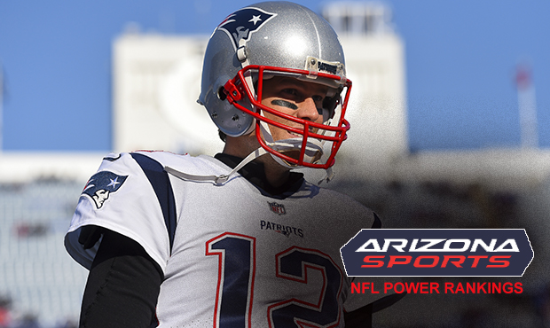 New England Patriots quarterback Tom Brady (12) walks on the field prior to an NFL football game ag...