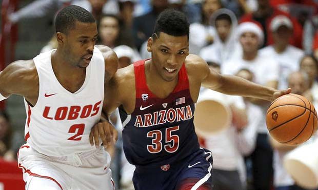 Arizona's Allonzo Trier tries to dribble past New Mexico's Sam Logwood in the first half of an NCAA...