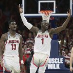 Arizona's Rawle Alkins (1) and Deandre Ayton (13) celebrate during the final seconds of the team's 84-78 victory over No. 3 Arizona State during an NCAA college basketball game, Saturday, Dec. 30, 2017, in Tucson, Ariz. (AP Photo/Ralph Freso)