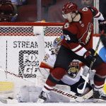 Arizona Coyotes right wing Christian Fischer (36) redirects the puck past Florida Panthers goalie James Reimer (34) for a goal during the first period of an NHL hockey game, Tuesday, Dec. 19, 2017, in Glendale, Ariz. (AP Photo/Ross D. Franklin)