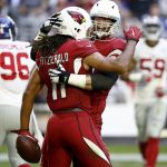 Arizona Cardinals wide receiver Larry Fitzgerald (11) celebrates his touchdown with offensive guard Alex Boone during the first half of an NFL football game against the New York Giants, Sunday, Dec. 24, 2017, in Glendale, Ariz. (AP Photo/Ross D. Franklin)