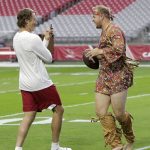 Arizona Cardinals quarterback Matt Barkley, right, smiles as he wears a costume and poses for a picture for Cardinals quarterback Blaine Gabbert, left, prior to an NFL football game against the Tennessee Titans after Barkley lost a quarterback challenge in practice, Sunday, Dec. 10, 2017, in Glendale, Ariz. (AP Photo/Rick Scuteri)