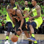 Minnesota Timberwolves guard Jeff Teague (0) and center Gorgui Dieng, back left, try to block Phoenix Suns guard Isaiah Canaan (2) in the first quarter of an NBA basketball game on Saturday, Dec. 16, 2017, in Minneapolis. (AP Photo/Andy Clayton-King)