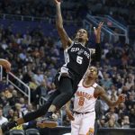 San Antonio Spurs guard Dejounte Murray (5) drives to the basket past Phoenix Suns' Tyler Ulis during the first half of an NBA basketball game Saturday, Dec. 9, 2017, in Phoenix. (AP Photo/Ralph Freso)