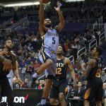 Memphis Grizzlies guard Andrew Harrison (5) drives to the basket past Phoenix Suns' Greg Monroe (14), T.J. Warren (12) and Tyler Ulis (8) during the first half of an NBA basketball game Thursday, Dec. 21, 2017, in Phoenix. (AP Photo/Ralph Freso)