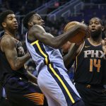 Memphis Grizzlies forward JaMychal Green, center, battles for a rebound with Phoenix Suns' Greg Monroe (14) and Marquese Chriss during the first half of an NBA basketball game Thursday, Dec. 21, 2017, in Phoenix. (AP Photo/Ralph Freso)