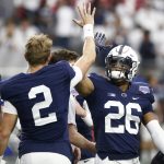 Penn State running back Saquon Barkley (26) high fives quarterback Tommy Stevens (2) prior to the Fiesta Bowl NCAA college football game against Washington, Saturday, Dec. 30, 2017, in Glendale, Ariz. (AP Photo/Ross D. Franklin)