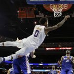 Phoenix Suns' Marquese Chriss, top, goes flying after trying to dunk over Philadelphia 76ers' Dario Saric during the first half of an NBA basketball game, Monday, Dec. 4, 2017, in Philadelphia. (AP Photo/Matt Slocum)