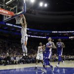 Phoenix Suns' Devin Booker (1) goes up for a dunk during the second half of an NBA basketball game against the Philadelphia 76ers, Monday, Dec. 4, 2017, in Philadelphia. Phoenix won 115-101. (AP Photo/Matt Slocum)