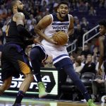 Minnesota Timberwolves center Karl-Anthony Towns (32) drives against Phoenix Suns center Tyson Chandler in the first quarter during an NBA basketball game, Saturday, Dec. 23, 2017, in Phoenix. (AP Photo/Rick Scuteri)