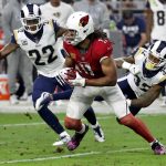 Arizona Cardinals wide receiver Larry Fitzgerald (11) makes the catch as Los Angeles Rams cornerback Troy Hill (32, and cornerback Trumaine Johnson (22) defends during the second half of an NFL football game, Sunday, Dec. 3, 2017, in Glendale, Ariz. (AP Photo/Rick Scuteri)