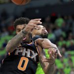 Phoenix Suns forward Marquese Chriss (0) and Minnesota Timberwolves center Taj Gibson (67) fight for a rebound in the first quarter of an NBA basketball game on Saturday, Dec. 16, 2017, in Minneapolis. (AP Photo/Andy Clayton-King)