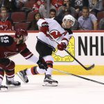 New Jersey Devils' Taylor Hall (9) shoots the puck as Arizona Coyotes' Jason Demers (55) defends during the third period of an NHL hockey game, Saturday, Dec. 2, 2017, in Glendale, Ariz. The Coyotes defeated the Devils 5-0. (AP Photo/Ralph Freso)