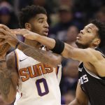 Phoenix Suns forward Marquese Chriss, left, keeps the ball away from Sacramento Kings forward Skal Labissiere during the first quarter of an NBA basketball game Tuesday, Dec. 12, 2017, in Sacramento, Calif. (AP Photo/Rich Pedroncelli)
