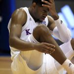 Kansas guard Malik Newman holds his head after an injury during the second half of an NCAA college basketball game against Arizona State in Lawrence, Kan., Sunday, Dec. 10, 2017. (AP Photo/Orlin Wagner)