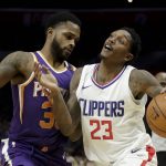 Los Angeles Clippers guard Lou Williams, right, is fouled by Phoenix Suns guard Troy Daniels during the second half of an NBA basketball game in Los Angeles, Wednesday, Dec. 20, 2017. The Clippers won 108-95. (AP Photo/Chris Carlson)