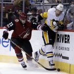 Arizona Coyotes defenseman Alex Goligoski (33) and Pittsburgh Penguins right wing Patric Hornqvist battle for the puck in the third period during an NHL hockey game, Saturday, Dec 16, 2017, in Glendale, Ariz. Pittsburgh defeated Arizona 4-2. (AP Photo/Rick Scuteri)