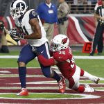 Los Angeles Rams tight end Gerald Everett (81) scores a touchdown as Arizona Cardinals safety Budda Baker (36) defends during the first half of an NFL football game, Sunday, Dec. 3, 2017, in Glendale, Ariz. (AP Photo/Ross D. Franklin)