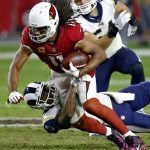 Arizona Cardinals wide receiver Larry Fitzgerald (11) is hit against the Los Angeles Rams during the second half of an NFL football game, Sunday, Dec. 3, 2017, in Glendale, Ariz. The Rams won 32-16. (AP Photo/Ross D. Franklin)