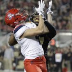 Arizona wide receiver Tony Ellison, left, makes a touchdown catch in front of Purdue safety Navon Mosley during the first half of the Foster Farms Bowl NCAA college football game Wednesday, Dec. 27, 2017, in Santa Clara, Calif. (AP Photo/Marcio Jose Sanchez)