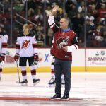 Arizona Diamondbacks manager Torey Luvullo waves to the crowd before taking part in the ceremonial puck drop prior to an NHL hockey game between the Arizona Coyotes and New Jersey Devils, Saturday, Dec. 2, 2017, in Glendale, Ariz. (AP Photo/Ralph Freso)