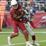 Arizona Cardinals wide receiver Larry Fitzgerald (11) scores a touchdown as New York Giants defensive back Brandon Dixon (25) defends during the first half of an NFL football game, Sunday, Dec. 24, 2017, in Glendale, Ariz. (AP Photo/Rick Scuteri)