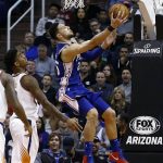 Philadelphia 76ers guard Ben Simmons, right, shoots as he gets past Phoenix Suns forward Marquese Chriss, left, during the second half of an NBA basketball game Sunday, Dec. 31, 2017, in Phoenix. The 76ers defeated the Suns 123-110. (AP Photo/Ross D. Franklin)