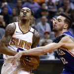 Philadelphia 76ers guard T.J. McConnell (12) strips Phoenix Suns guard Tyler Ulis, left, of the ball during the second half of an NBA basketball game Sunday, Dec. 31, 2017, in Phoenix. The 76ers defeated the Suns 123-110. (AP Photo/Ross D. Franklin)
