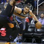 Memphis Grizzlies center Marc Gasol, right, drives to the basket past the defense of Phoenix Suns' Greg Monroe during the first half of an NBA basketball game Thursday, Dec. 21, 2017, in Phoenix. (AP Photo/Ralph Freso)