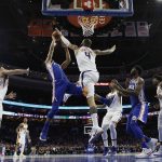 Phoenix Suns' Tyson Chandler (4) blocks a shot by Philadelphia 76ers' Timothe Luwawu-Cabarrot (7) during the second half of an NBA basketball game, Monday, Dec. 4, 2017, in Philadelphia. (AP Photo/Matt Slocum)
