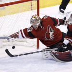 Arizona Coyotes goalie Antti Raanta (32) makes a diving save against the Tampa Bay Lightning as Coyotes defenseman Jason Demers (55) looks on during the first period of an NHL hockey game, Thursday, Dec. 14, 2017, in Glendale, Ariz. (AP Photo/Ross D. Franklin)