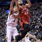 Toronto Raptors guard Fred VanVleet (23) drives to the basket as Phoenix Suns guard Devin Booker (1) defends during the second half of an NBA basketball game Tuesday, Dec. 5, 2017, in Toronto. (Nathan Denette/The Canadian Press via AP)