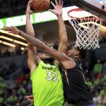 Minnesota Timberwolves forward Karl-Anthony Towns (32) is fouled by Phoenix Suns forward Marquese Chriss (0) in the fourth quarter of an NBA basketball game on Saturday, Dec. 16, 2017, in Minneapolis. (AP Photo/Andy Clayton-King)