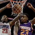 Los Angeles Clippers guard Lou Williams, left, dunks next to Phoenix Suns forward Danuel House Jr. during the second half of an NBA basketball game in Los Angeles, Wednesday, Dec. 20, 2017. The Clippers won 108-95. (AP Photo/Chris Carlson)
